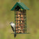 Wild Delight Seed Block Feeder with a peaked roof, showcasing a Downy Woodpecker feeding on the seed block, ideal for backyard bird watching.