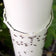 Nectar Fortress Natural Hummingbird Ant Repellent applied near a PVC pipe joint with ants clustering, showcasing its effectiveness in repelling ants outdoors.
