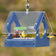 Duncraft Songbird Mealworm Magnet Feeder with birds feeding through fly-through openings, featuring a clear plastic roof and metal mesh flooring.