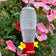 Garden Stake Hummingbird Feeder & Hanging Rod, featuring a clear plastic cup with 2 feeding ports and built-in bee guard, set in a garden planter.